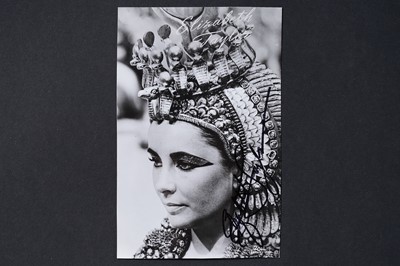Lot 732 - An Elizabeth Taylor autographed black and white photographic postcard