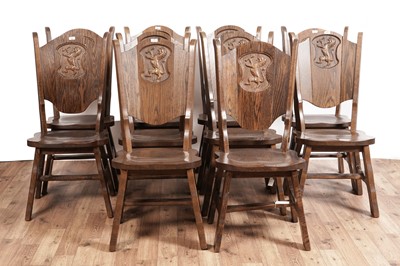 Lot 77 - A set of ten oak heraldic dining chairs