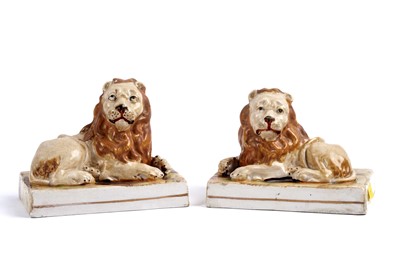 Lot 323 - A pair Staffordshire models of recumbent lions