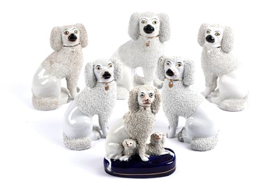Lot 303 - A collection of six Victorian Staffordshire pottery poodles