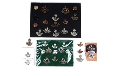 Lot 5 - A selection of Durham Light Infantry cap badges, titles, and buttons