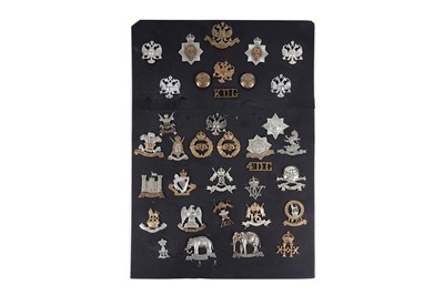 Lot 8 - A display of cap badges, titles and buttons for Dragoon Guard, Lancer and Hussar Regiments