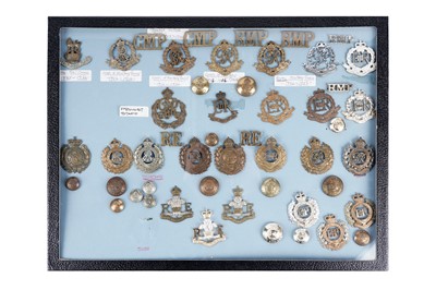 Lot 13 - A display of Royal Military Police and Royal Engineers cap badges, titles and buttons