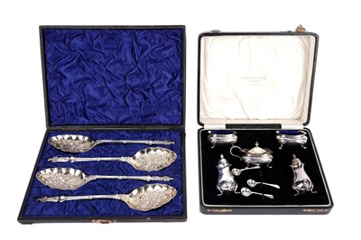 Lot 325 - A cased George V silver condiment set; and a cased set of berry spoons