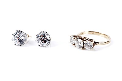 Lot 77 - A three stone dress ring; and a pair of stud earrings