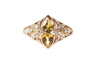Lot 661 - A fancy yellow sapphire and diamond ring