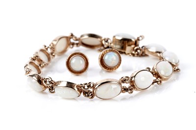 Lot 73 - An opal cabochon bracelet; and a pair of opal stud earrings