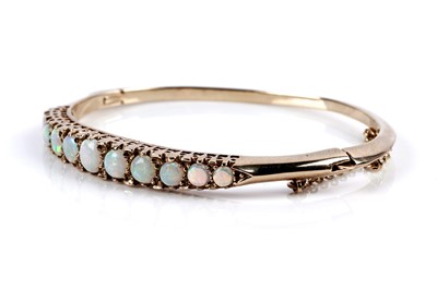 Lot 637 - An Edwardian opal and 9ct yellow gold bangle