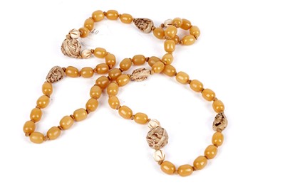 Lot 242 - A Chinese butterscotch amber style bead necklace