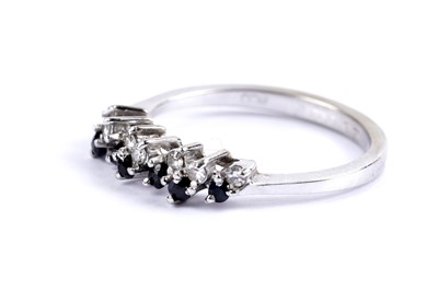Lot 35 - A diamond and sapphire half eternity ring