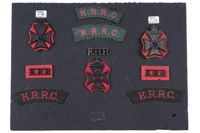 Lot 59 - The King’s Royal Rifle Corps cap badges, titles and cloth badges