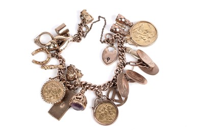 Lot 654 - A 9ct rose gold charm bracelet set with gold coins and other charms