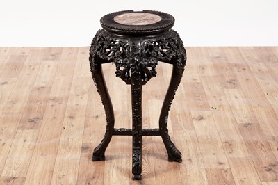 Lot 411 - An early 20th Century Chinese carved hardwood jardinière stand