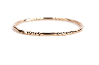 Lot 629 - A 9ct yellow gold twist pattern bangle