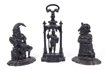 Lot 128 - A pair of Punch and Judy cast metal door stops; and another