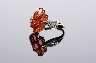 Lot 606 - A fire opal and white stone ring