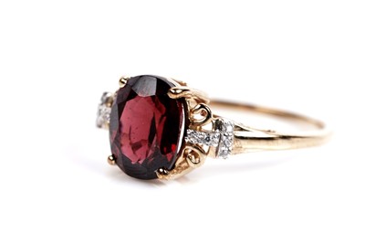 Lot 609 - A garnet and white sapphire dress ring