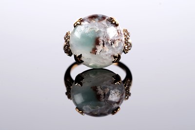 Lot 610 - A circular cabochon dress ring