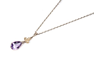 Lot 154 - An Edwardian amethyst and seed pearl drop pendant necklace