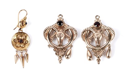 Lot 160 - A pair of garnet set ram's head pattern charm pendants; and an earring