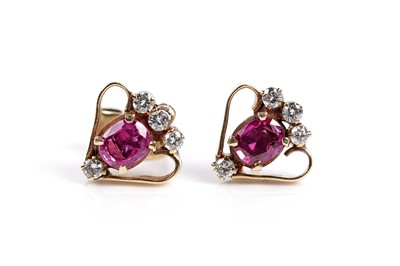 Lot 673 - A pair of ruby and diamond earrings