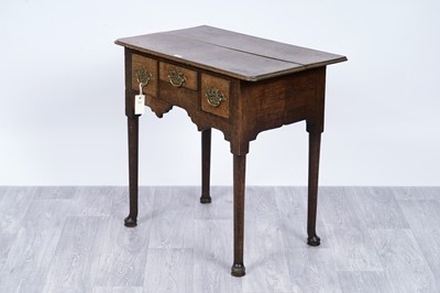 Lot 104 - A George III oak lowboy
