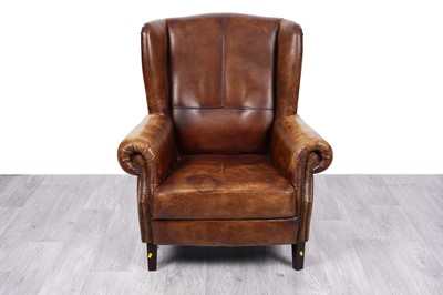 Lot 3 - After Timothy Oulton: a ‘Halo’ style wingback brown leather armchair