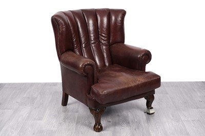 Lot 6 - An oxblood leather barrel back armchair