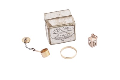 Lot 256 - Channel Isles (Guernsey): a small gold wedding band; and two 9ct gold charms