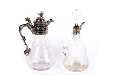 Lot 338 - An Edwardian silver mounted glass claret jug; and another