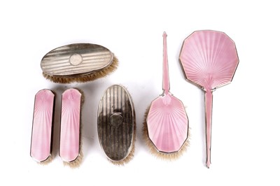 Lot 339 - An Art Deco pink guilloche enamel dressing table set; and a pair of clothes brushes