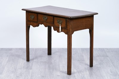 Lot 106 - A George III oak lowboy