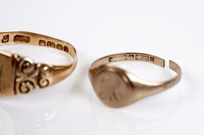 Lot 595 - A 22ct gold wedding band; two gold signet rings; and another ring