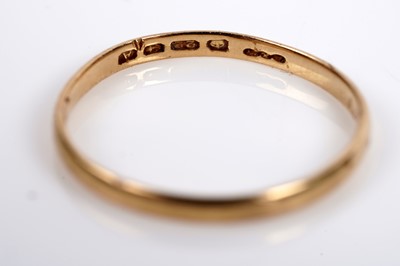 Lot 595 - A 22ct gold wedding band; two gold signet rings; and another ring