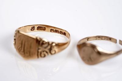 Lot 595 - A 22ct gold wedding band; two gold signet rings; and another ring