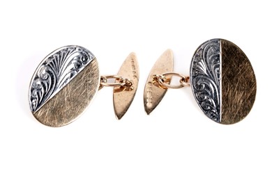 Lot 677 - A pair of bi-colour gold cufflinks
