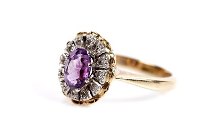 Lot 621 - An amethyst and diamond cluster dress ring