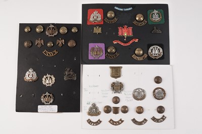 Lot 89 - Three displays of cap badges, collar badges, buttons and titles