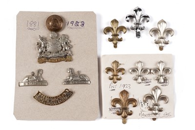 Lot 93 - A display of Manchester Regiment badges, buttons and titles; and fleur-de-lys badges