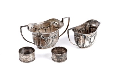 Lot 827 - An Edwardian silver cream jug and sugar bowl; and two napkin rings