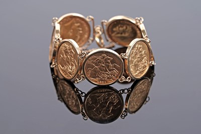 Lot 696 - A gold bracelet set with seven sovereign coins