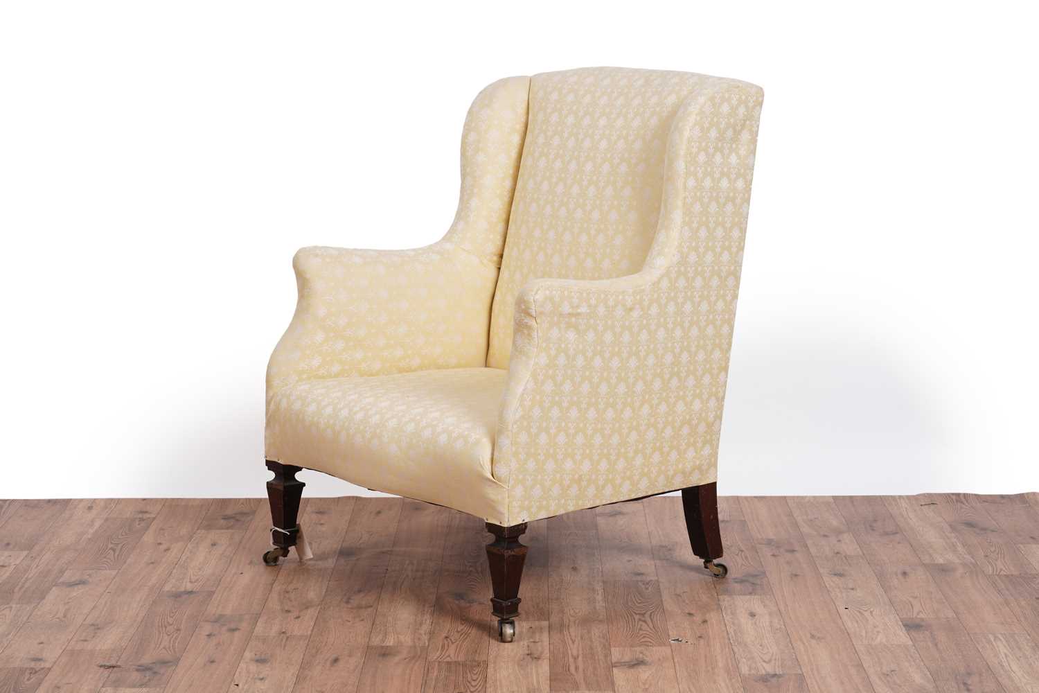 Lot 467 - Howard & Sons style: an early 20th Century wingback armchair
