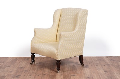 Lot 467 - Howard & Sons style: an early 20th Century wingback armchair