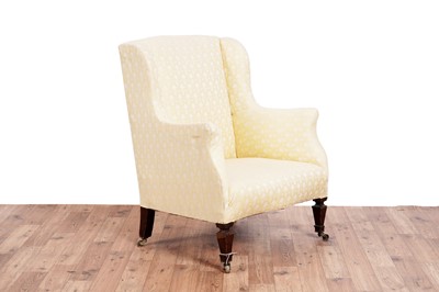 Lot 467 - Howard & Sons style: an early 20th Century wingback armchair