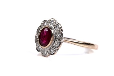 Lot 556 - A ruby and diamond flowerhead pattern ring