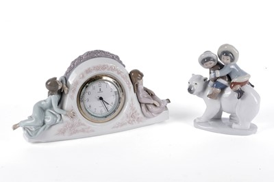 Lot 858 - A Lladro ‘Eskimo Riders’ figure; and a Lladro ‘Two Sisters Clock’ figure