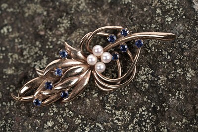 Lot 518 - A sapphire and pearl stylized sprig brooch