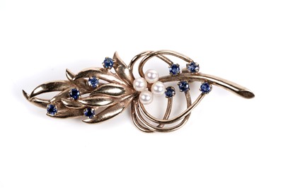 Lot 518 - A sapphire and pearl stylized sprig brooch