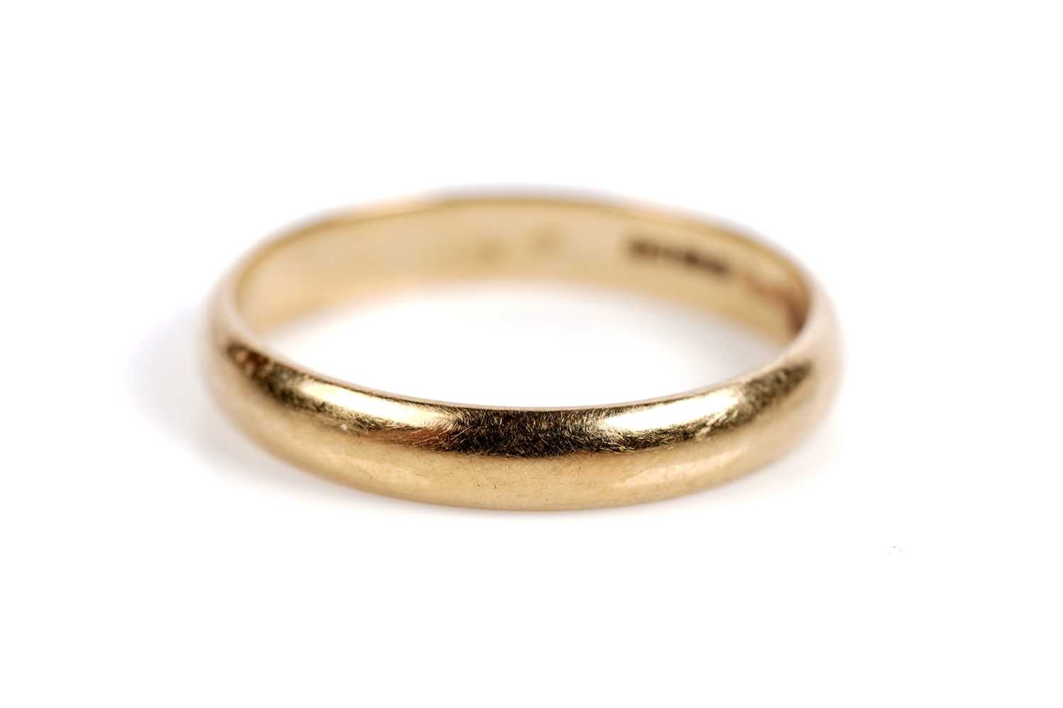 Lot 525 - A ruby and diamond ring; and an 18ct gold wedding band