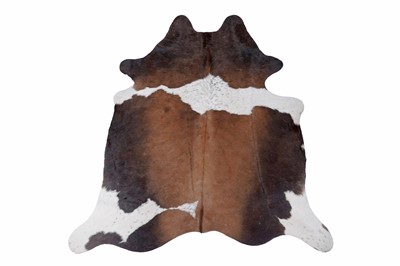 Lot 494 - A cow hide rug